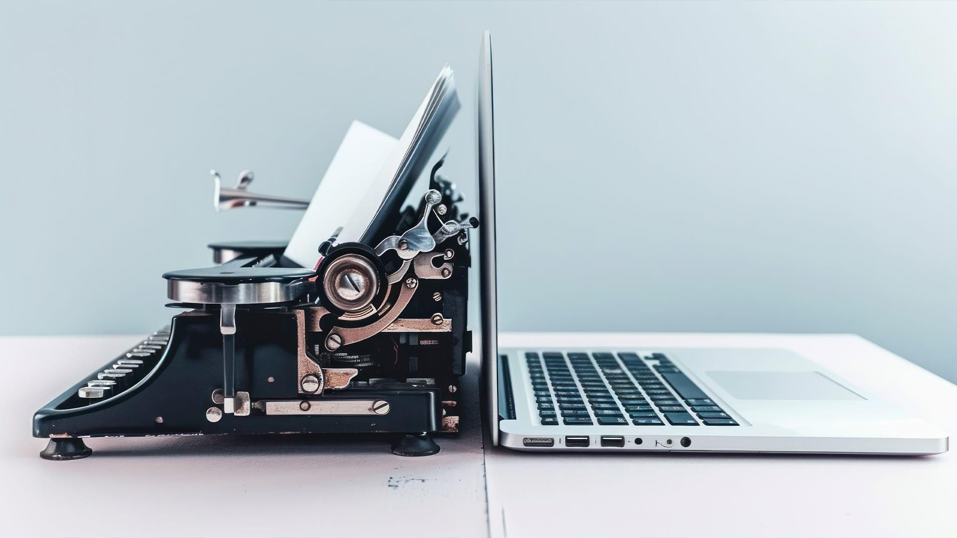 Typewriter next to laptop