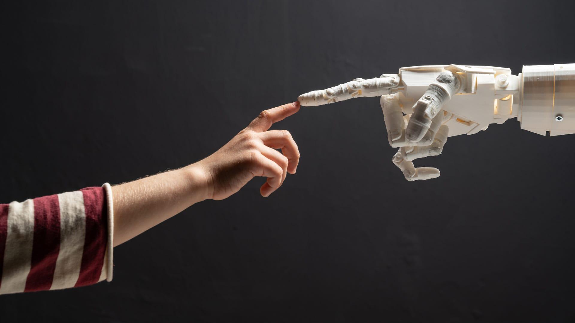 Index fingers touch of robot and person