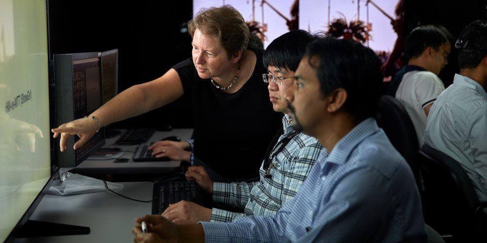 Group of scientists looking at a computer screen 